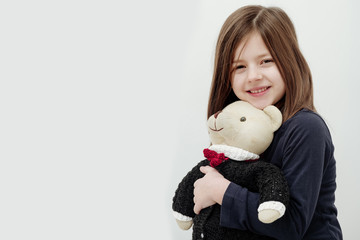Happy cute girl hugging cute, teddy bear toy
