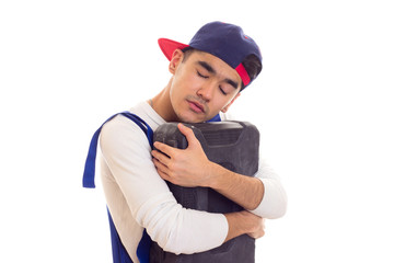 Young man in overall holding toolbox