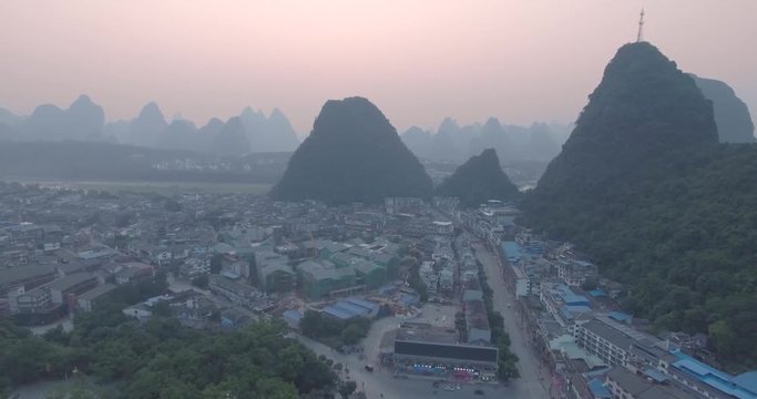 Top view of amaizing famous Yangshuo valley in Guilin, Guangxi, China. Aerial View of beautiful sunrise over Yangshuo Town in Guilin, China. Overpopulation concept, beauty in nature