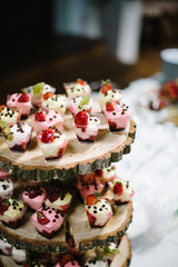 delicious decorated sweets on wooden table, cocktails party catering