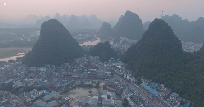 Top view of amaizing famous Yangshuo valley in Guilin, Guangxi, China. Aerial View of beautiful sunrise over Yangshuo Town in Guilin, China. Overpopulation concept, beauty in nature