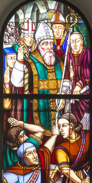 Stained glass window with colored glass depicting the bishop St. Ambrose of Milan