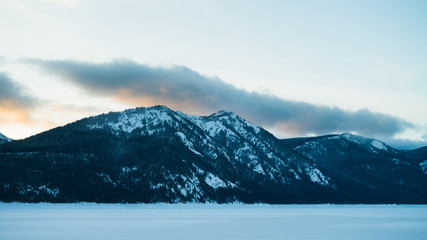 Mountain and frozen lake at sunset