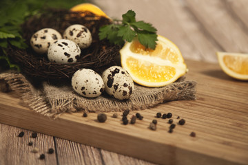Quail eggs - Quail eggs in a ceramic bowl on old brown wooden surface background, selective focus. Top view.