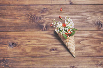 Bouquet of wild cherries in a waffle cup