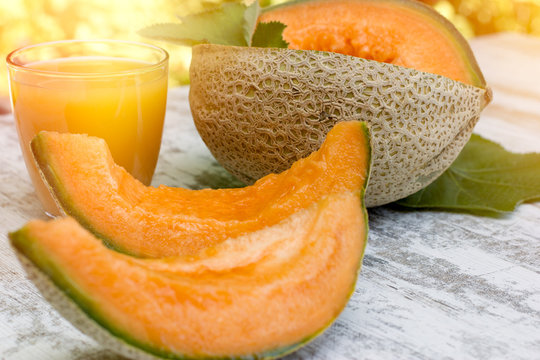 Fresh, tasty and juicy melon - cantaloupe and melon juice (smoothie) on table