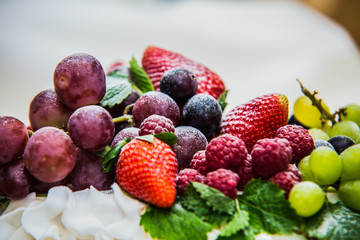 Fresh mixed fruits on plate over white background.