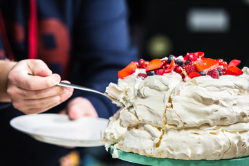Cake Pavlova with cream and fresh fruits.