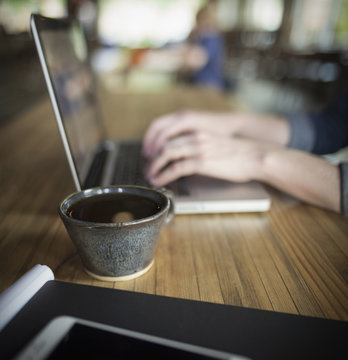Woman Working Remotely on Laptop in Coffee Shop