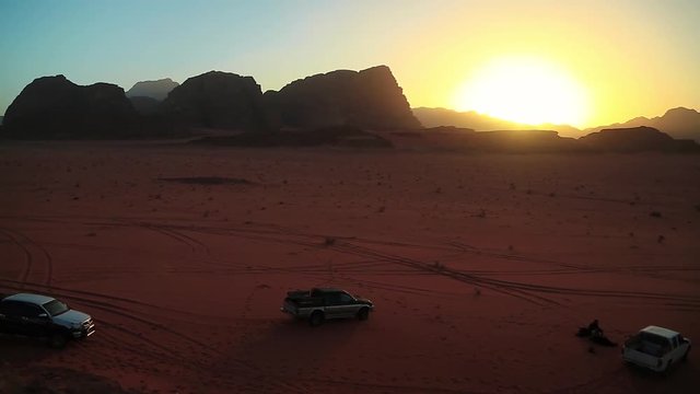 Cars in Wadi Rum desert, Hashemite Kingdom of Jordan. Wadi Rum, also known as Valley of the Moon, is largest and picturesque desert in Jordan. Wadi is a term traditionally referring to a valley
