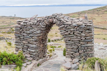 Stone arch on Pachatata hill on Amantani island in Titicaca lake, Peru