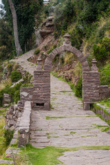 Fototapeta na wymiar Path through a gate on Taquile island in Titicaca lake, Peru