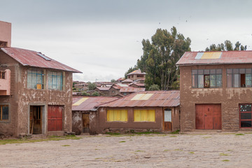 Houses on a central square in a village on Taquile island in Titicaca lake, Peru