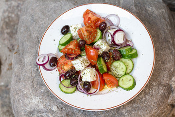 Greek salad with tomatoes, cucumbers, feta, red onions, olives