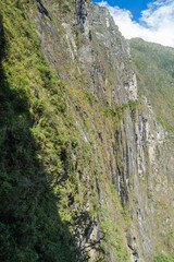 Inca trail carved into a stone wall near Machu Picchu ruins, Peru.