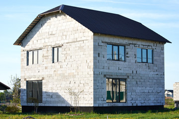 House building construction from autoclaved aerated concrete blocks. Unfinished house construction site.