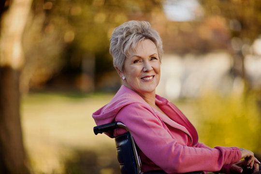 Smiling senior woman sitting in a wheelchair.