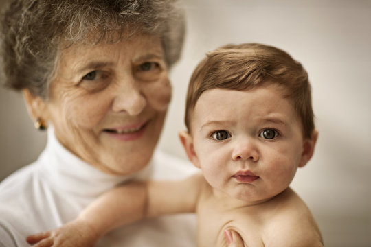 Portrait of a woman holding her granddaughter.
