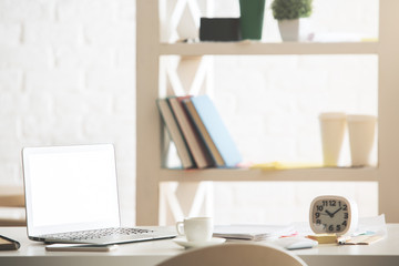 Office desktop with white laptop