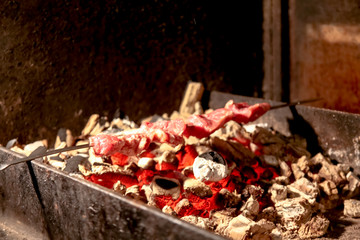 Naklejka na ściany i meble Shish kebab roasting over the red coals on the grill, barbecue.
