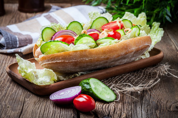 Homemade sandwich on a wooden table.