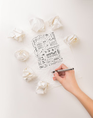 Fototapeta na wymiar Writing hand in crumpled paper