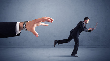 Businessman running from hand