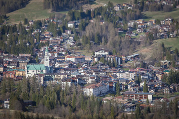 Fototapeta na wymiar Tilt shift panorama of Cortina d'Ampezzo downtown, Dolomites