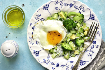 Avocado salad and fried egg - concept of healthy breakfast.Top view.