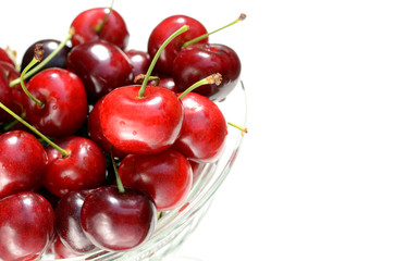 Fresh ripe red cherries berries in vintage crystal vase on old rustic wooden table