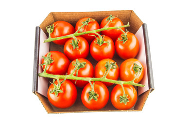 Cherry tomatoes in a box on a white background isolated.