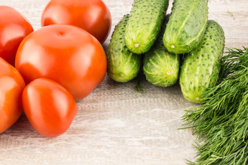 Cucumber, tomato, pepper and fennel on a white wooden background close up.