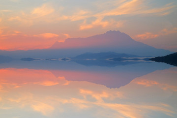 Beautiful reflection of Mount Kinabalu on peaceful river.