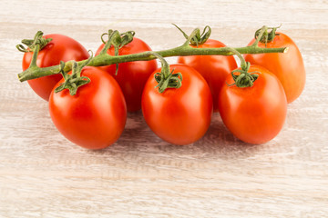 Tomatoes on a white wooden background close up.