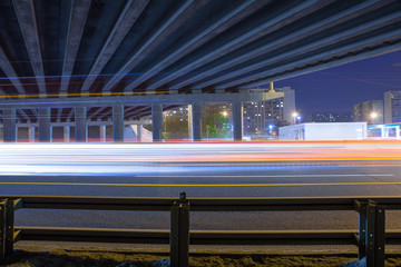Urban city road with car light trails at night	
