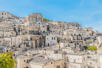 panoramic view of typical stones (Sassi di Matera) near gravina of Matera UNESCO European Capital of Culture 2019 on blue sky