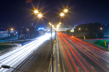 Urban city road with car light trails at night	