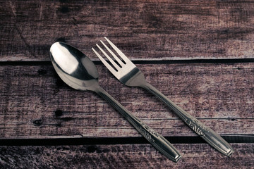 Fork and spoon on wooden table