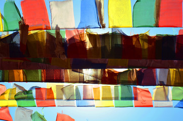 Colorful Buddhism prayer flags Dar Cho, lungta and sun in Svayambunatkh temple.