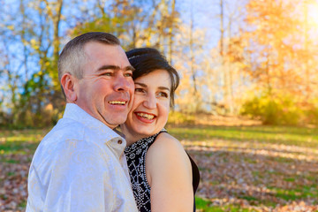 Beautiful couple girl and man walking in the park on fall day