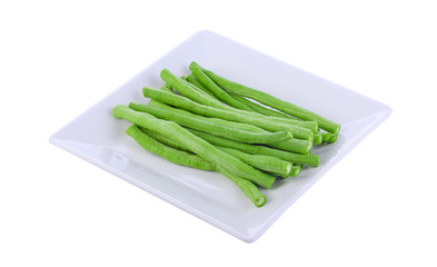 Yardlong bean isolated on tile dish with a white background.
