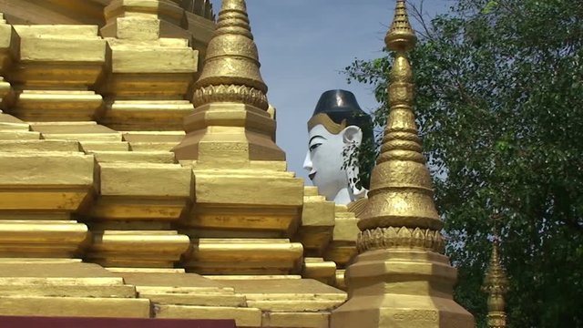 Pathein, Big Buddha statue behind a Pagoda
