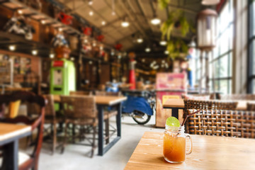 ice tea with slice of lemon in mason jar on the wooden table