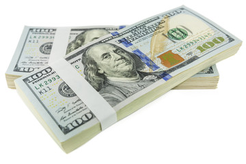 stack of one hundred dollar bill hangs over each other isolated on white background