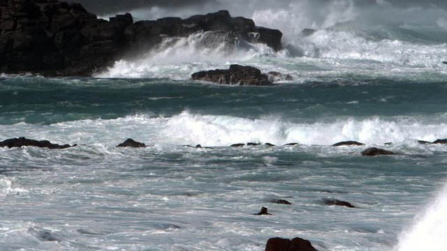 Ocean waves crashing on rocks in super slow motion