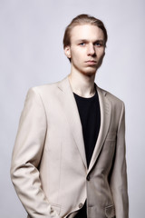 Young blond male model in beige man suit