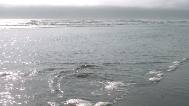 Waves rolling into the beach in slow motion