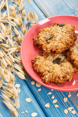 Fresh baked oatmeal cookies and ears of oat, healthy dessert concept
