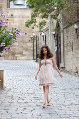 Young girl near old wall