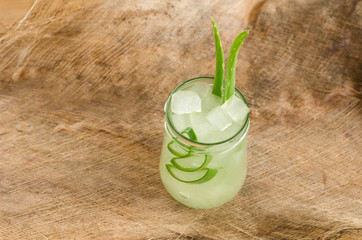 Aloe Vera plant sliced in glass on Coconut fiber background